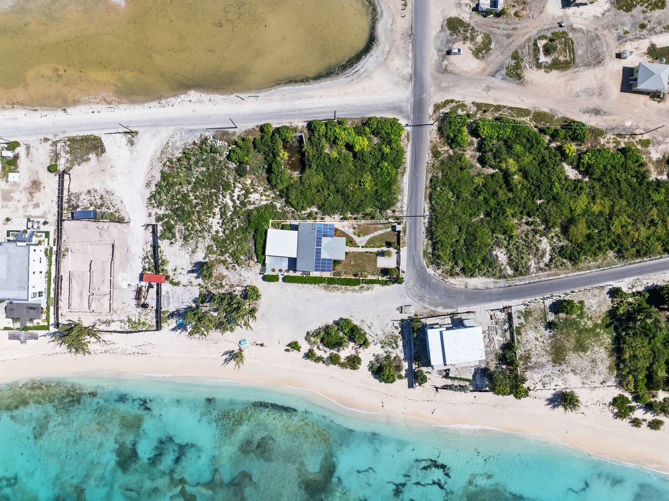 Drone view straight down on the villa, the beach and the reef